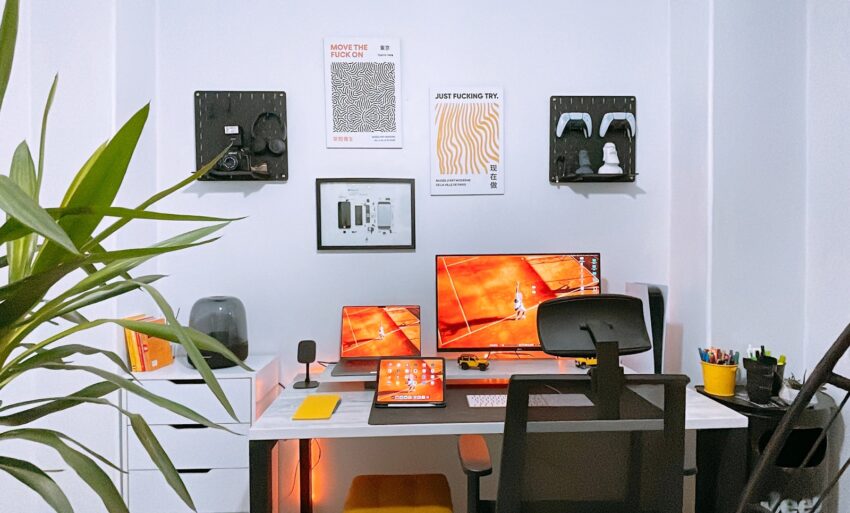 a desk with two monitors and a keyboard