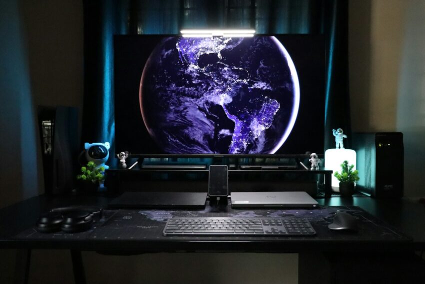 A desk with a monitor and keyboard on it